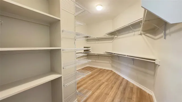 a view of a room with wooden floor