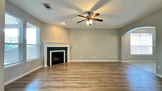 wooden floor in an empty room with a fireplace