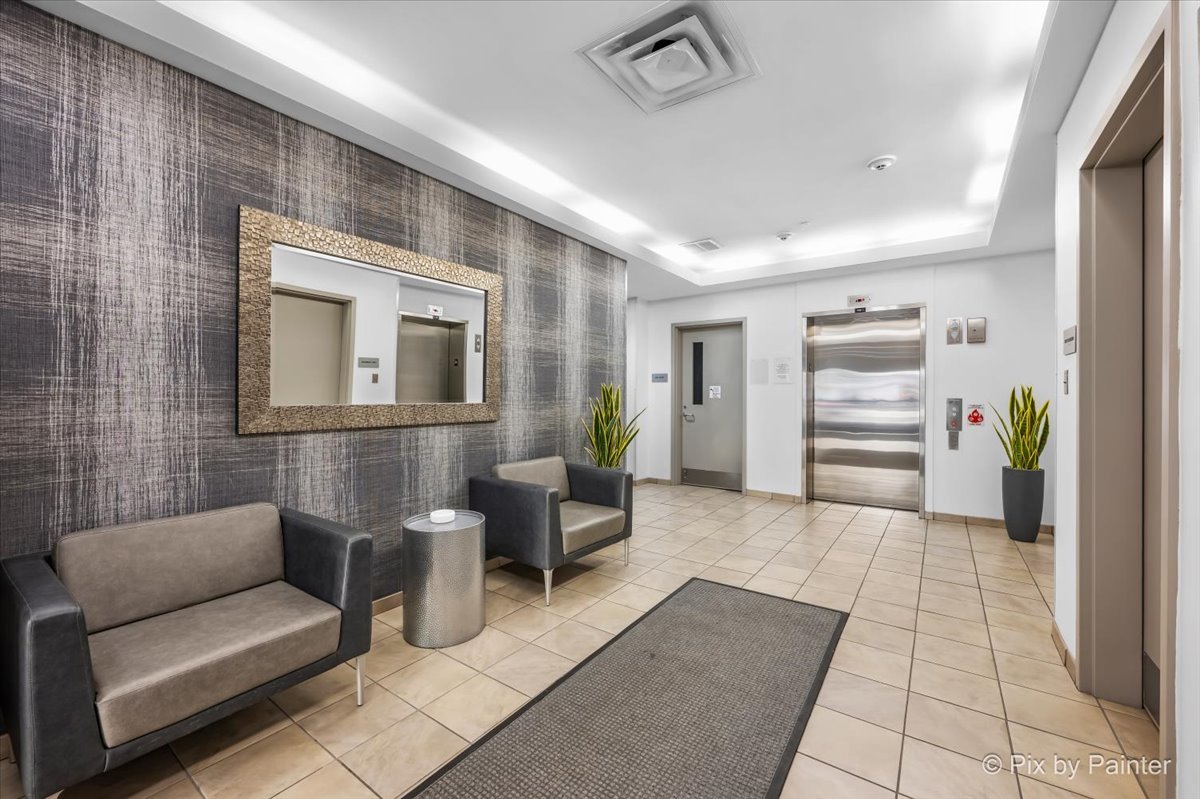 50 South Grove Avenue, Unit 301 Elgin, IL 60120 - Photo 18 of 25 a living room with furniture and a flat screen tv