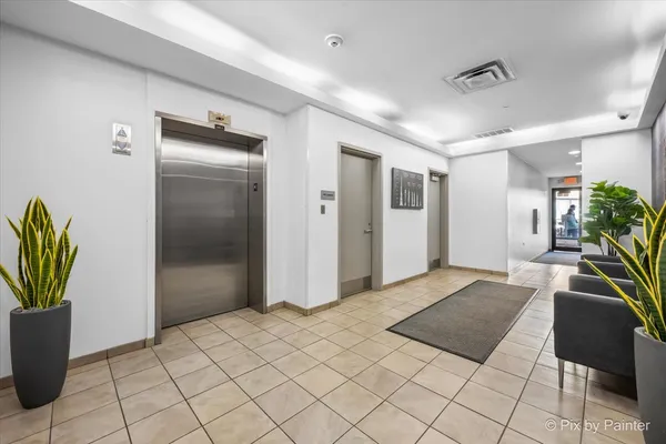 a spacious bedroom with a bed and a potted plant