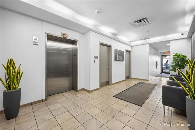 a spacious bedroom with a bed and a potted plant