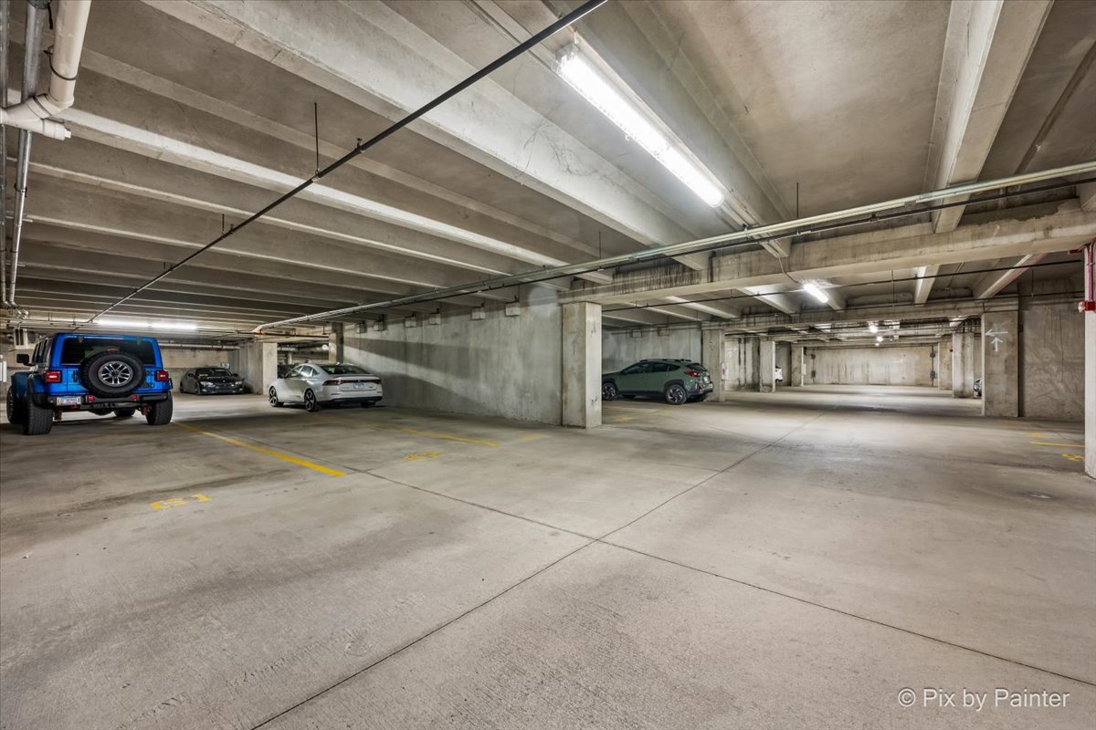 50 South Grove Avenue, Unit 301 Elgin, IL 60120 - Photo 20 of 25 a view of parking garage with cars