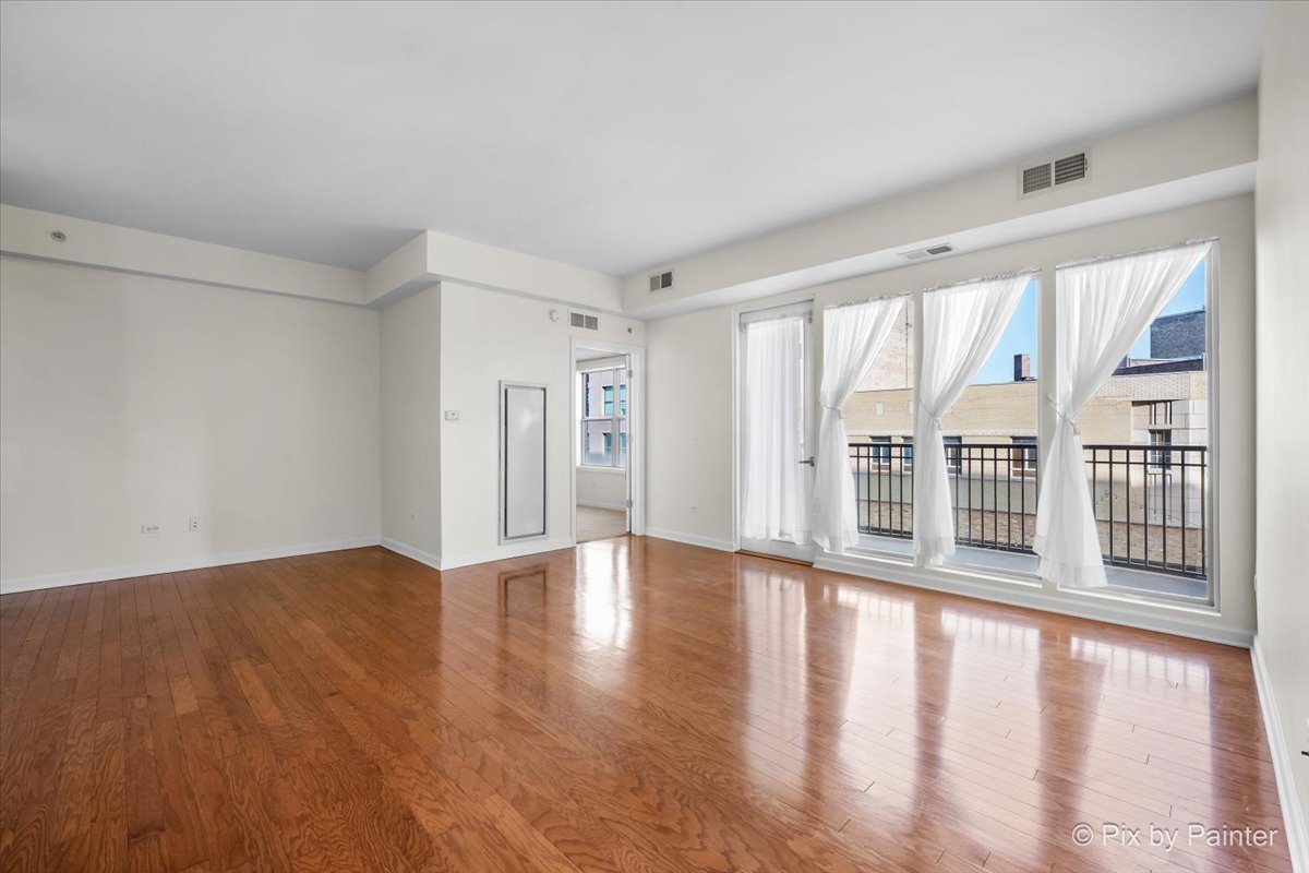 50 South Grove Avenue, Unit 301 Elgin, IL 60120 - Photo 3 of 25 wooden floor in an empty room with a window