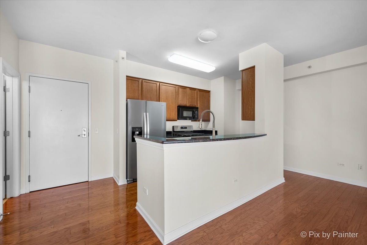 50 South Grove Avenue, Unit 301 Elgin, IL 60120 - Photo 9 of 25 a kitchen with stainless steel appliances a refrigerator and a stove