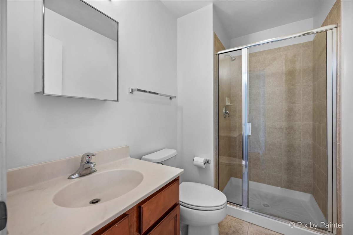 50 South Grove Avenue, Unit 301 Elgin, IL 60120 - Photo 10 of 25 a bathroom with a sink toilet and shower