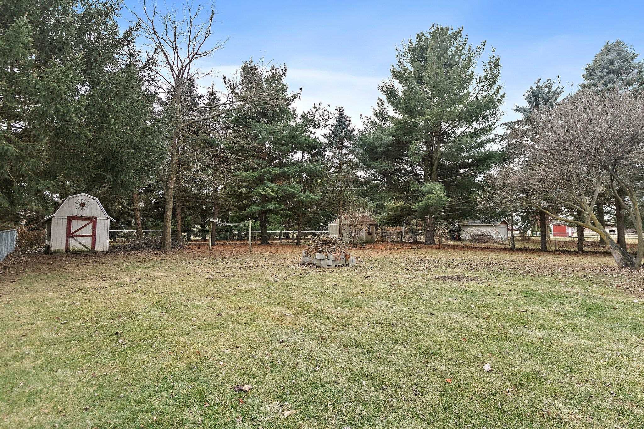 2783 Karr Road Belvidere, IL 61008 - Photo 16 of 17 a front view of a house with a yard and trees
