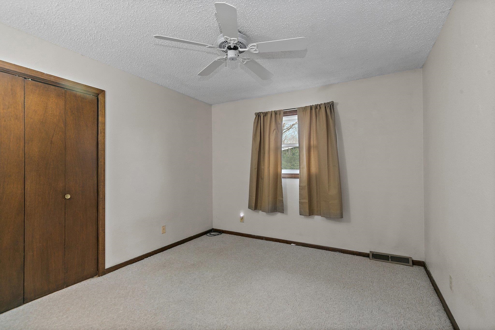 2783 Karr Road Belvidere, IL 61008 - Photo 9 of 17 an empty room with windows and fan