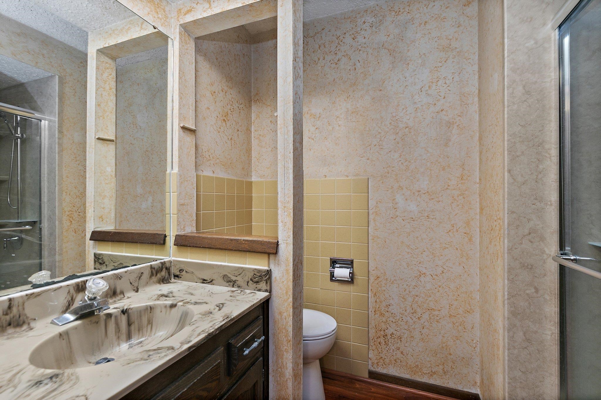 2783 Karr Road Belvidere, IL 61008 - Photo 10 of 17 a bathroom with a granite countertop sink toilet and shower