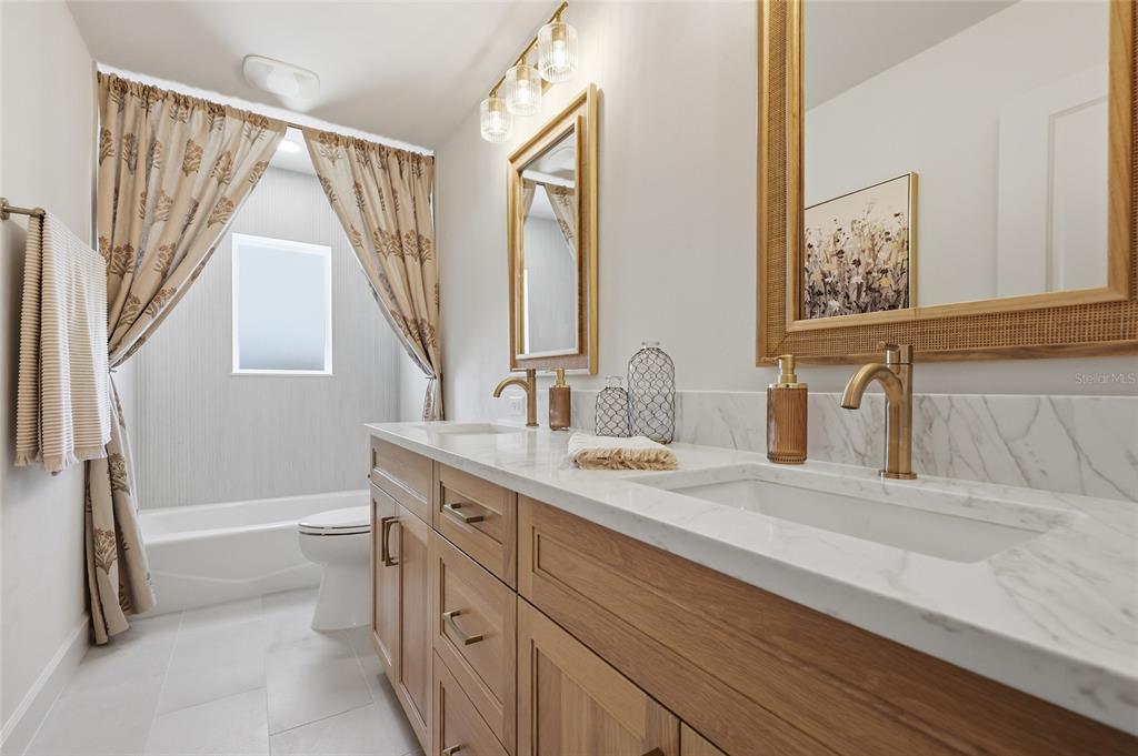 13125 Southwest 9th Road Newberry, FL 32669 - Photo 25 of 53 a spacious bathroom with a granite countertop sink a toilet a mirror and shower