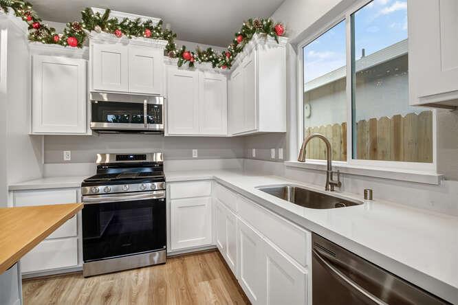 1480 Westwind Way Rocklin, CA 95765 - Photo 11 of 27 a kitchen with granite countertop a sink stove and microwave