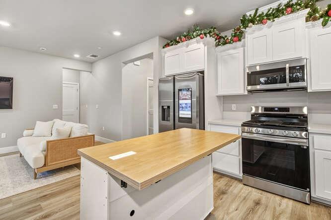 1480 Westwind Way Rocklin, CA 95765 - Photo 12 of 27 a kitchen with stainless steel appliances a stove a microwave a refrigerator a stove and white cabinets