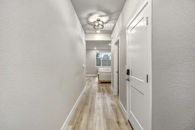 1480 Westwind Way Rocklin, CA 95765 - Photo 15 of 27 a view of a hallway with wooden floor and a bathroom