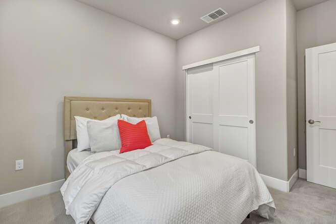 1480 Westwind Way Rocklin, CA 95765 - Photo 16 of 27 a bedroom with a large bed and a chandelier
