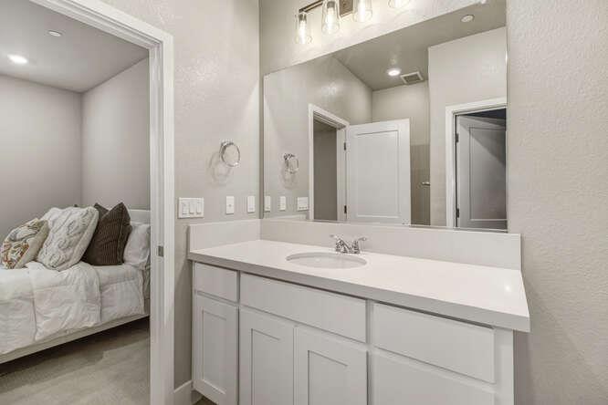 1480 Westwind Way Rocklin, CA 95765 - Photo 22 of 27 a en suite bathroom with a double vanity sink and mirror