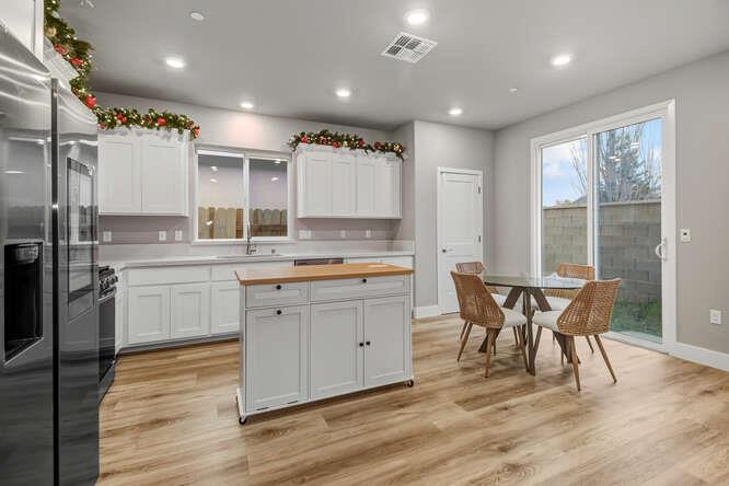 1480 Westwind Way Rocklin, CA 95765 - Photo 4 of 27 a kitchen with a table chairs sink refrigerator and cabinets
