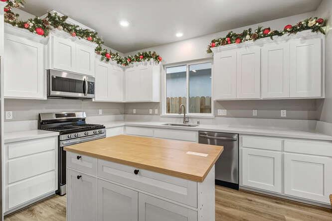 1480 Westwind Way Rocklin, CA 95765 - Photo 9 of 27 a kitchen with granite countertop a sink stove top oven and microwave