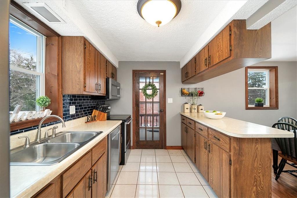 1028 McCoy Road McKees Rocks, PA 15136 - Photo 7 of 21 a kitchen with a sink stove and cabinets