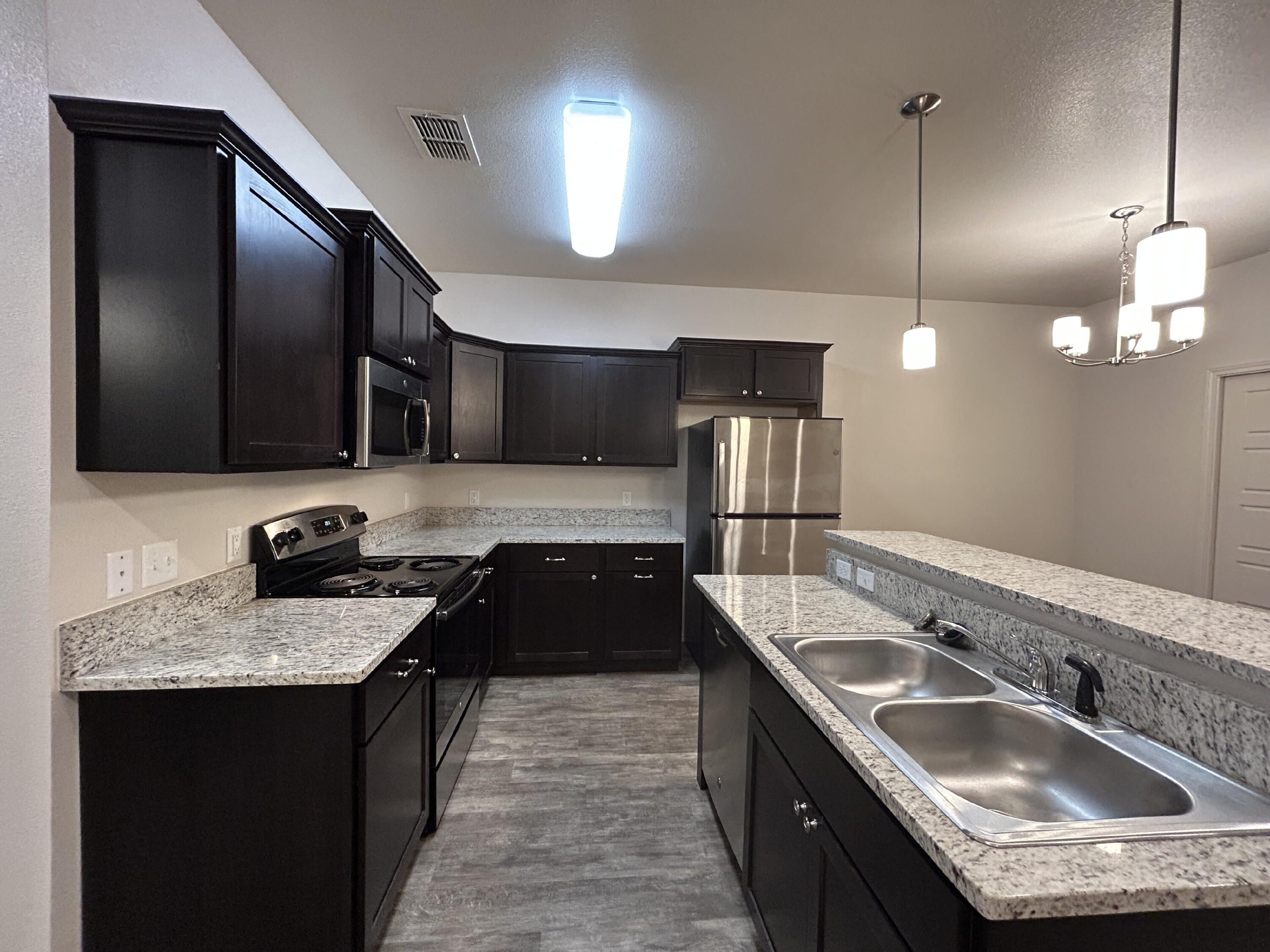 11620 Evanston Avenue Lubbock, TX 79424 - Photo 3 of 11 a kitchen with a sink stove and refrigerator