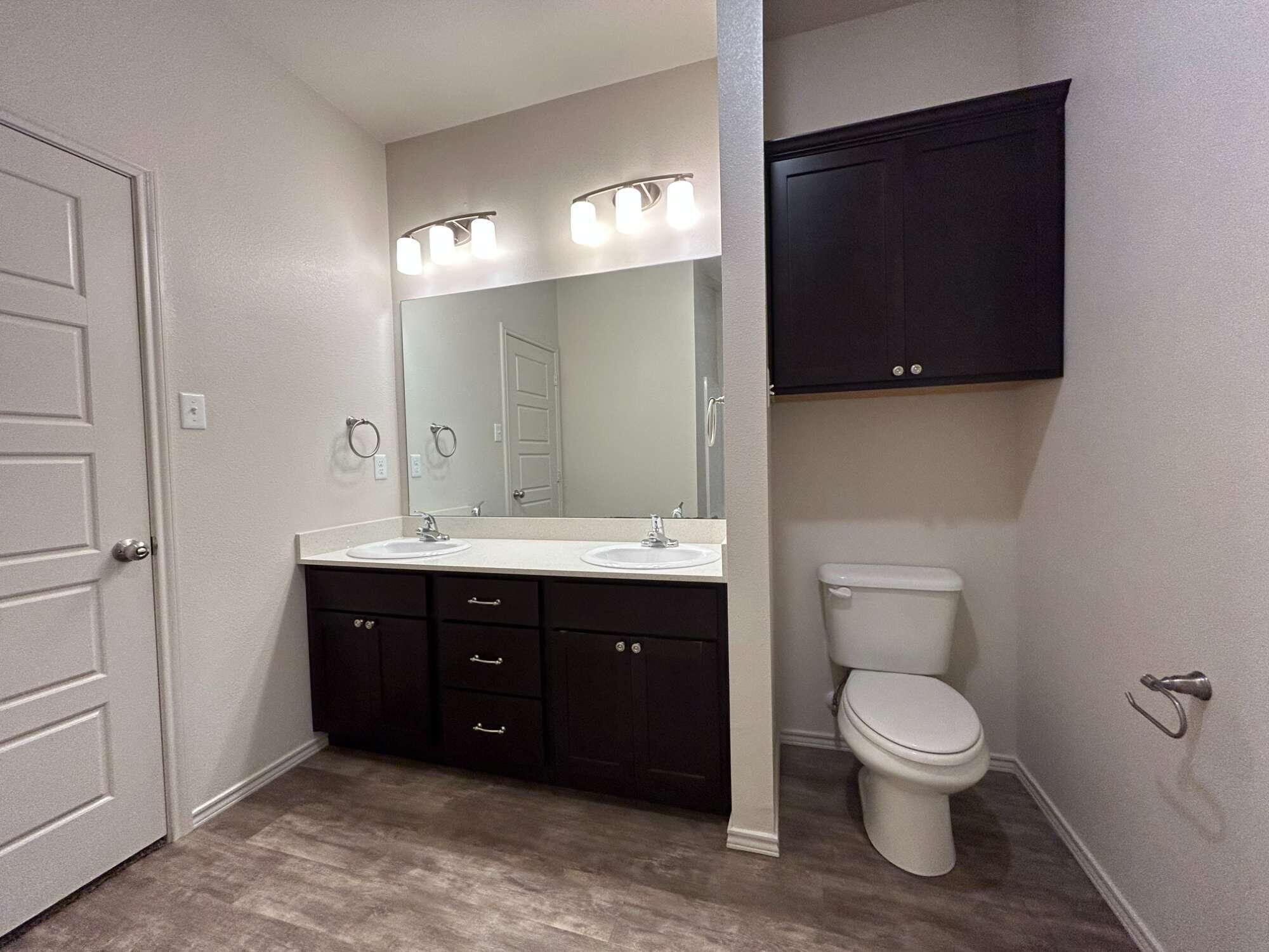 11620 Evanston Avenue Lubbock, TX 79424 - Photo 7 of 11 a bathroom with a toilet sink and mirror
