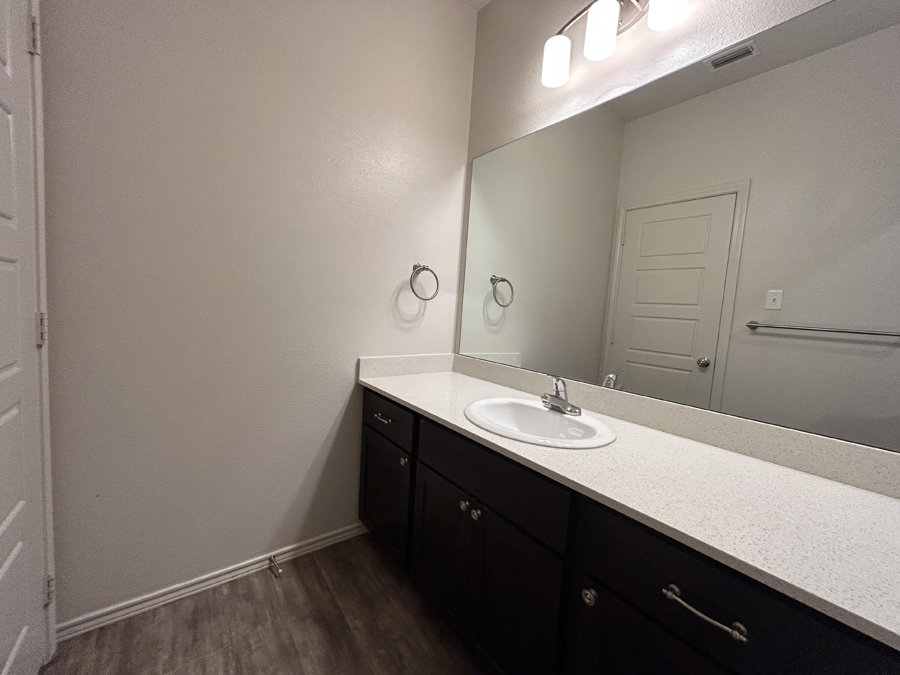 11620 Evanston Avenue Lubbock, TX 79424 - Photo 9 of 11 a bathroom with a sink a vanity and a mirror