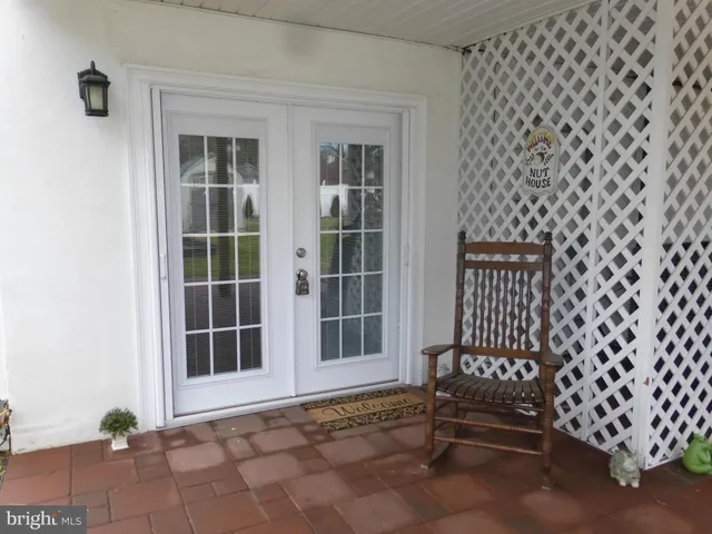 a view of a black door and chair