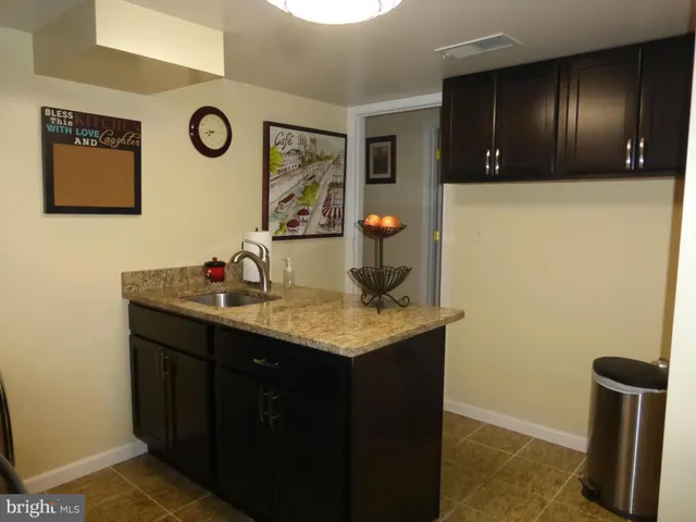 a kitchen with a sink a stove and a refrigerator