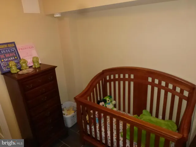 a view of an empty room with wooden floor and closet