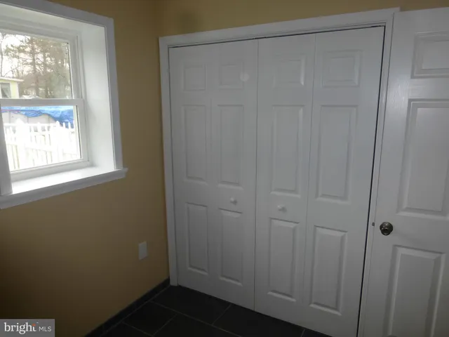a bathroom with a sink vanity mirror and toilet
