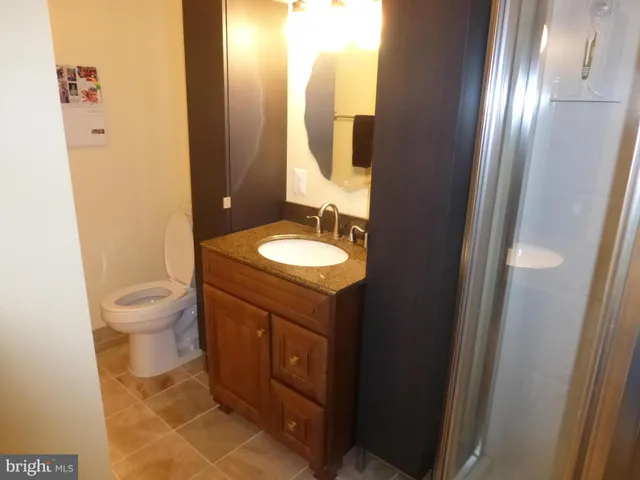 a view of a house with garden and a bench