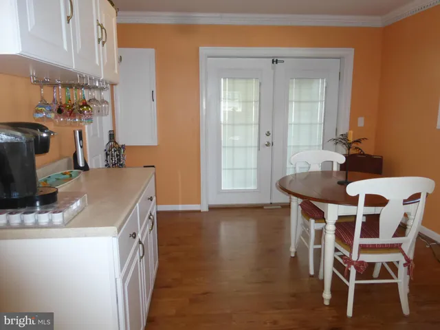 a kitchen with a table chairs and a refrigerator