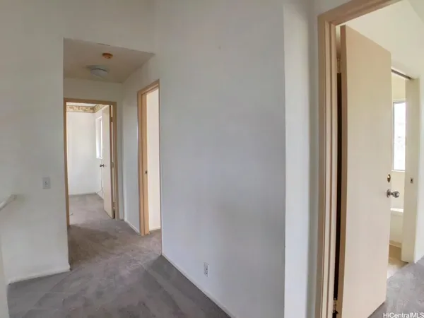 a view of a hallway with a wooden door
