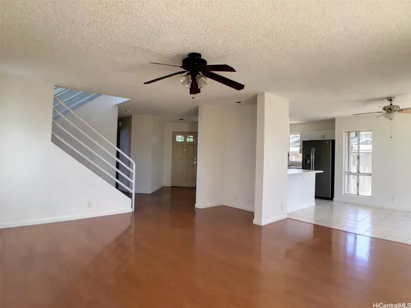 a view of an empty room with a kitchen