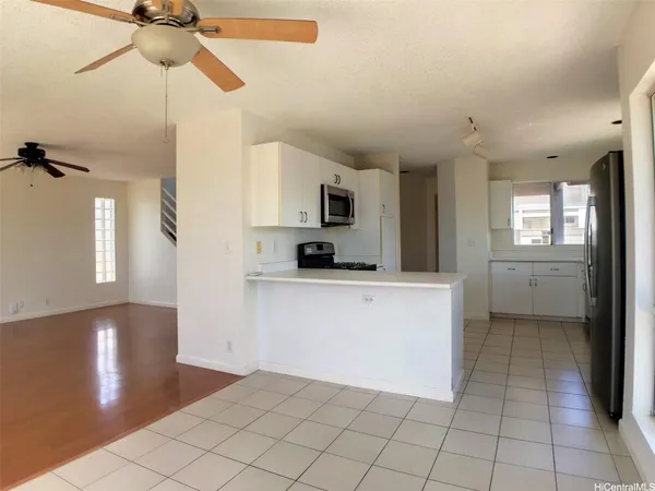 a kitchen with a sink a refrigerator and cabinets