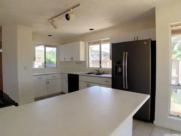 a kitchen with refrigerator and window