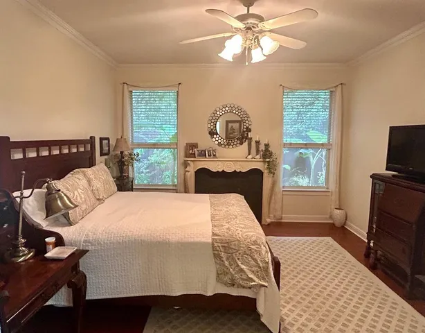 a bedroom with a bed and a tv