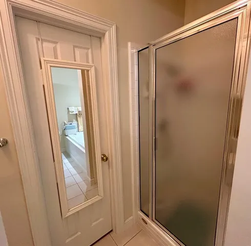a bathroom with a glass shower door