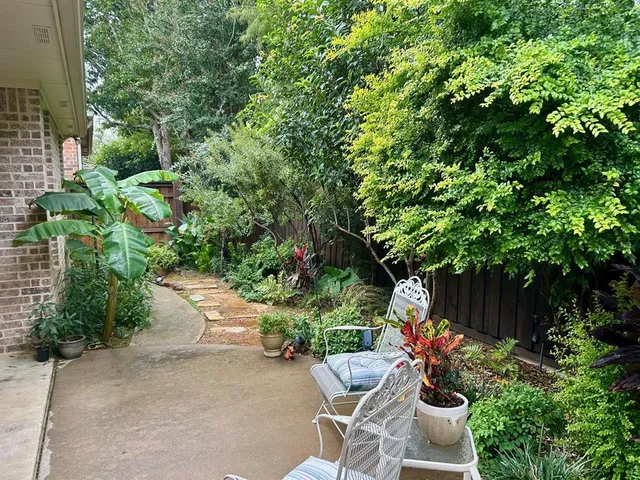 a garden with a table and a chairs