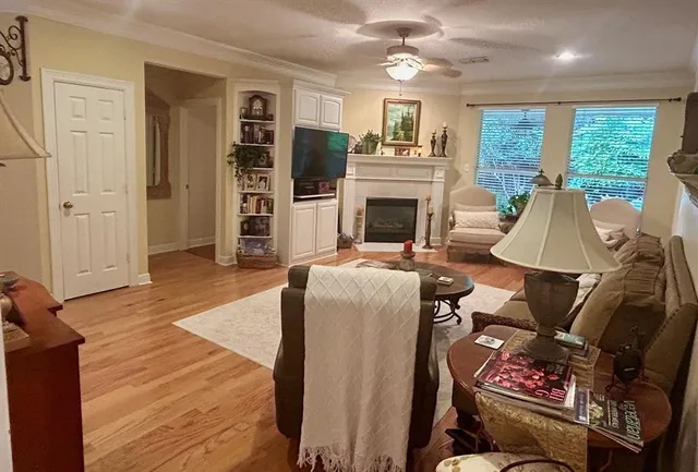 a living room with furniture a fireplace and a flat screen tv