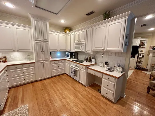 a kitchen with kitchen island granite countertop a sink cabinets and stainless steel appliances