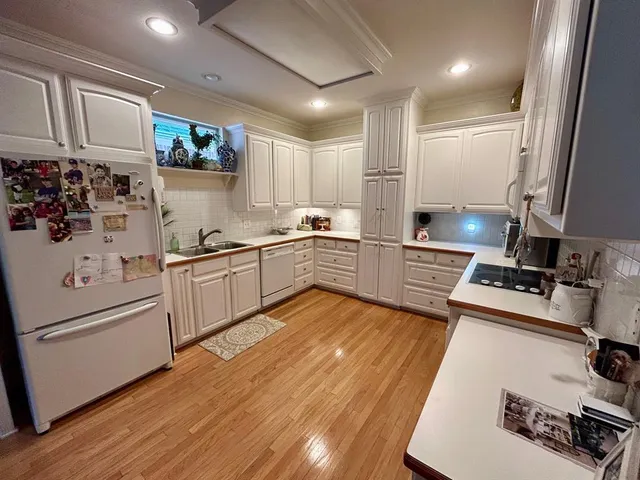 a kitchen with a sink appliances and cabinets