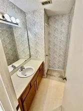 a bath room with a sink and a mirror