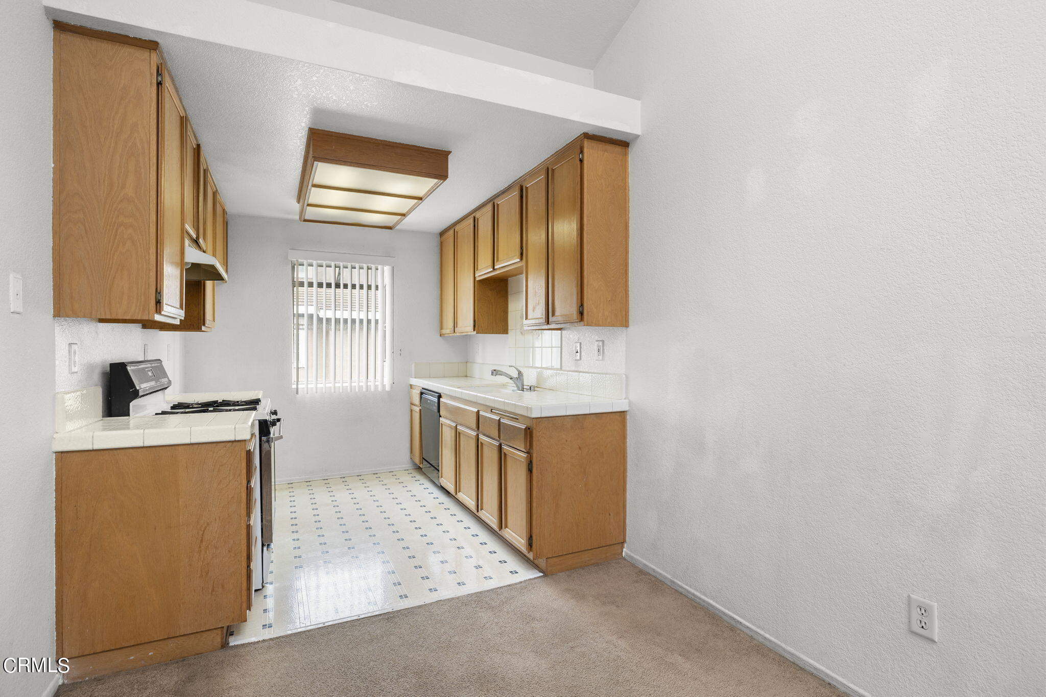 5182 Columbus Place Oxnard, CA 93033 - Photo 11 of 39 a view of a kitchen with sink dishwasher and microwave oven