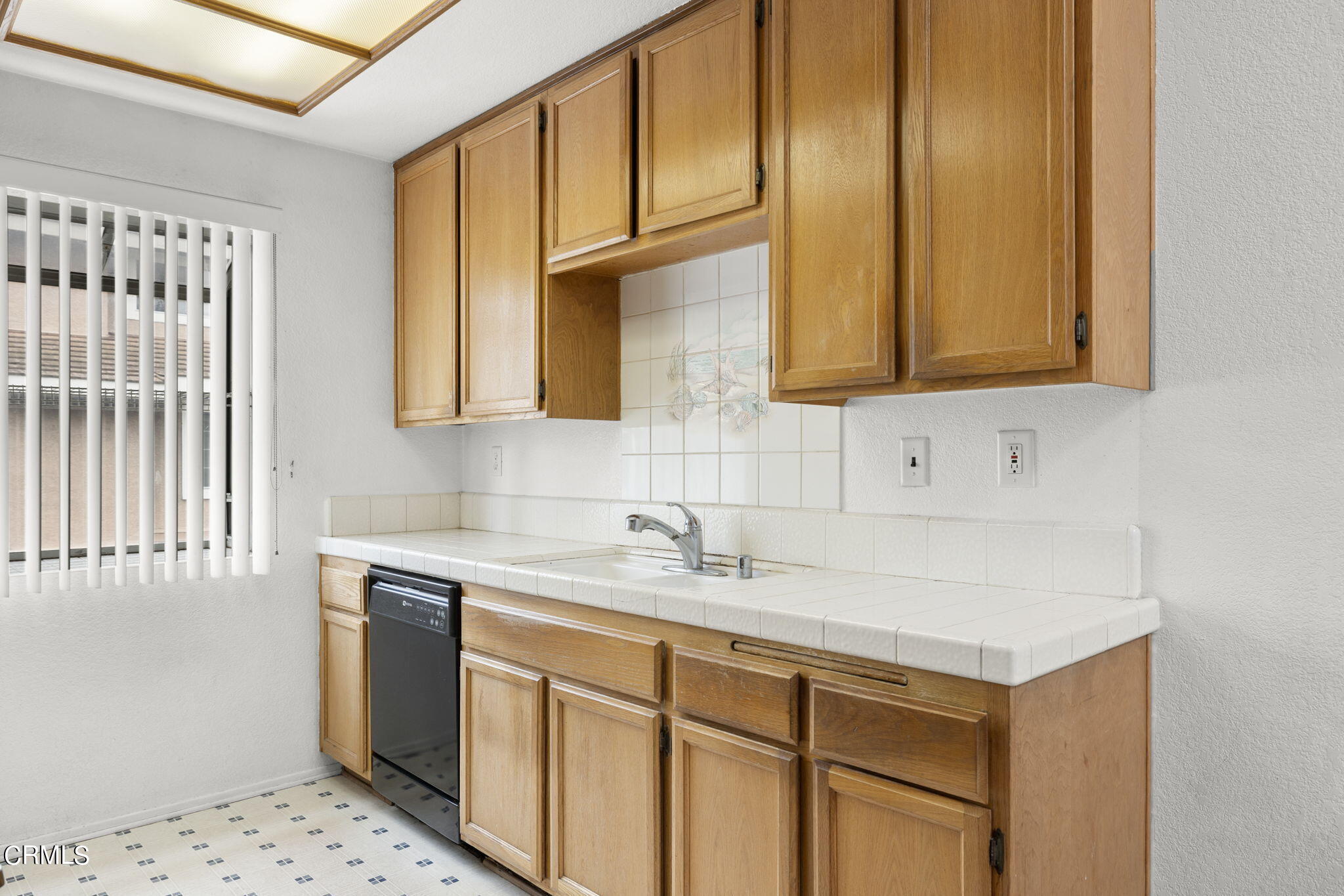 5182 Columbus Place Oxnard, CA 93033 - Photo 13 of 39 a kitchen with stainless steel appliances granite countertop a sink a stove and a microwave