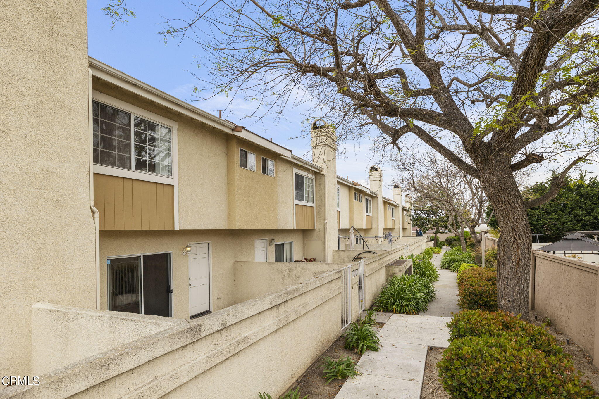 5182 Columbus Place Oxnard, CA 93033 - Photo 2 of 39 a view of a house with a large tree