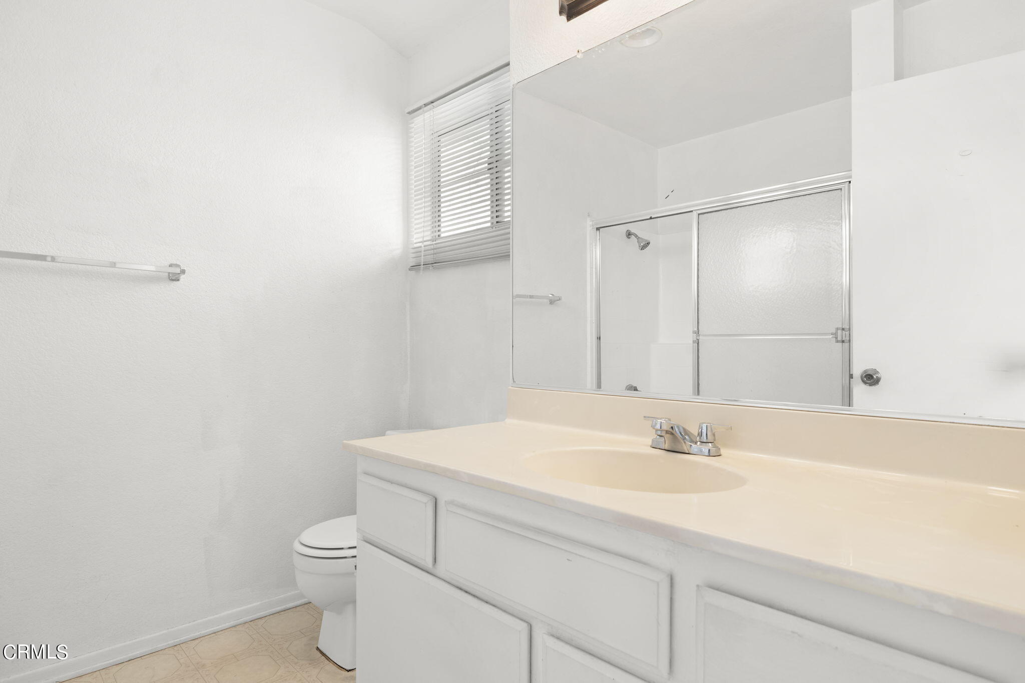 5182 Columbus Place Oxnard, CA 93033 - Photo 23 of 39 a bathroom with a sink a toilet and a mirror