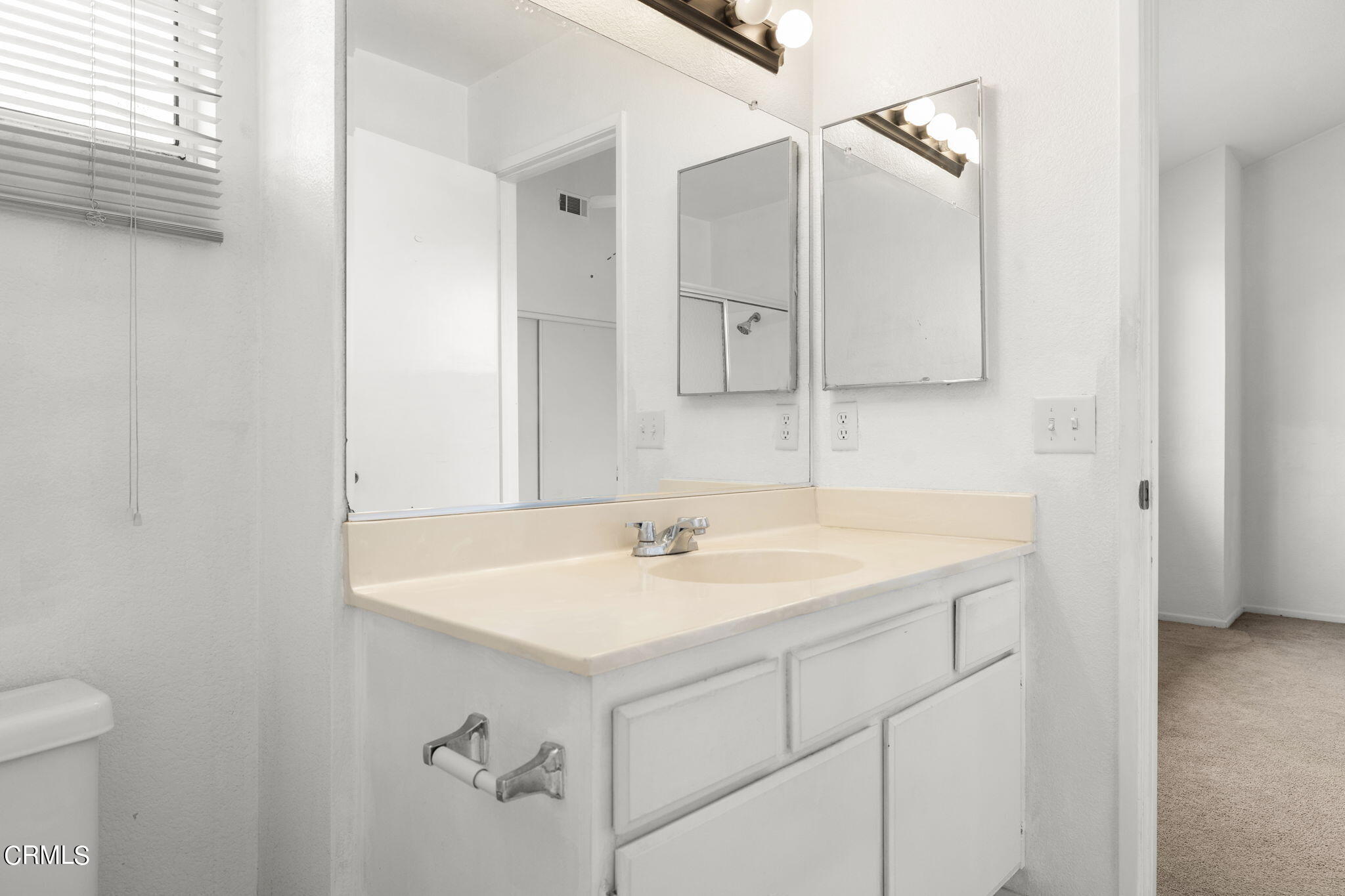 5182 Columbus Place Oxnard, CA 93033 - Photo 26 of 39 a bathroom with a sink and a mirror