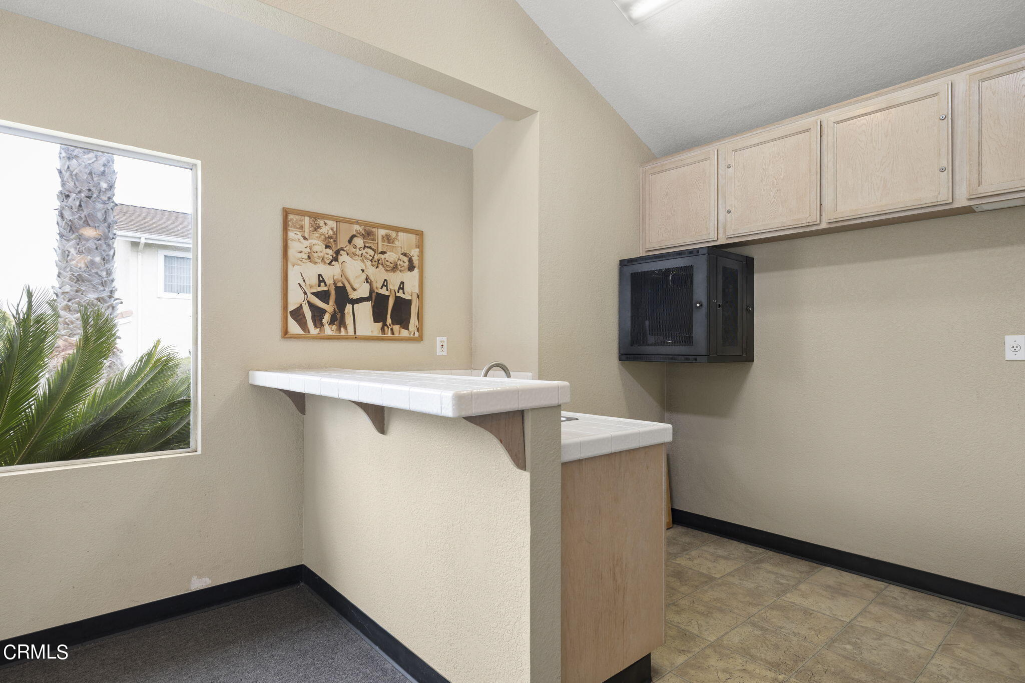 5182 Columbus Place Oxnard, CA 93033 - Photo 35 of 39 a view of cabinets with wooden floor and electronic appliances