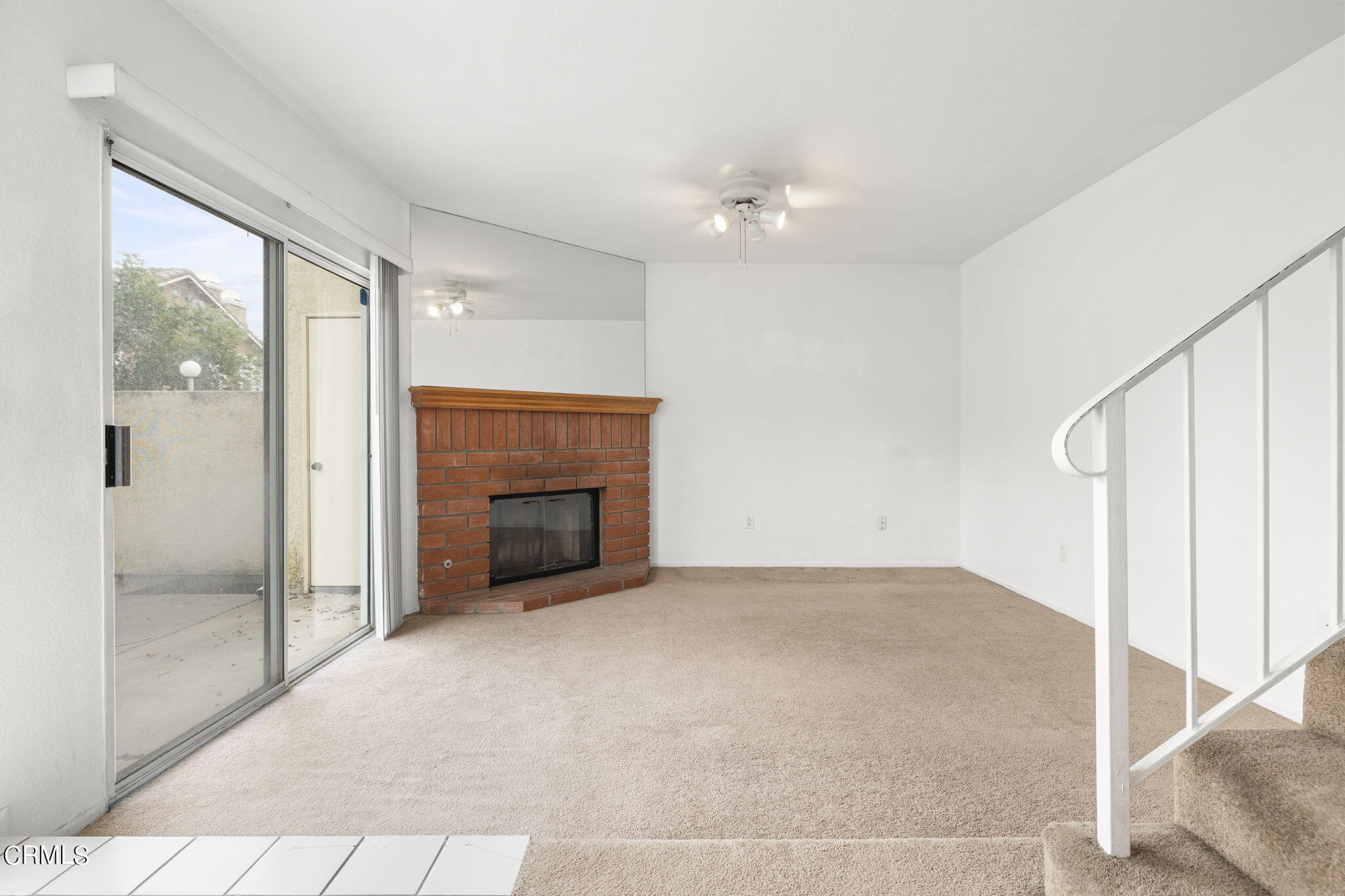 5182 Columbus Place Oxnard, CA 93033 - Photo 6 of 39 a view of an empty room with a fireplace and a window