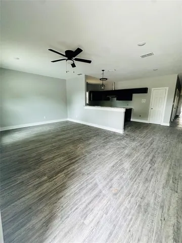 a view of a room with wooden floor