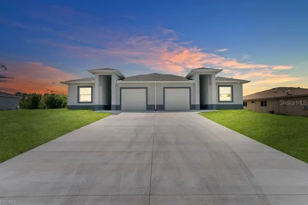 a front view of house with yard and green space